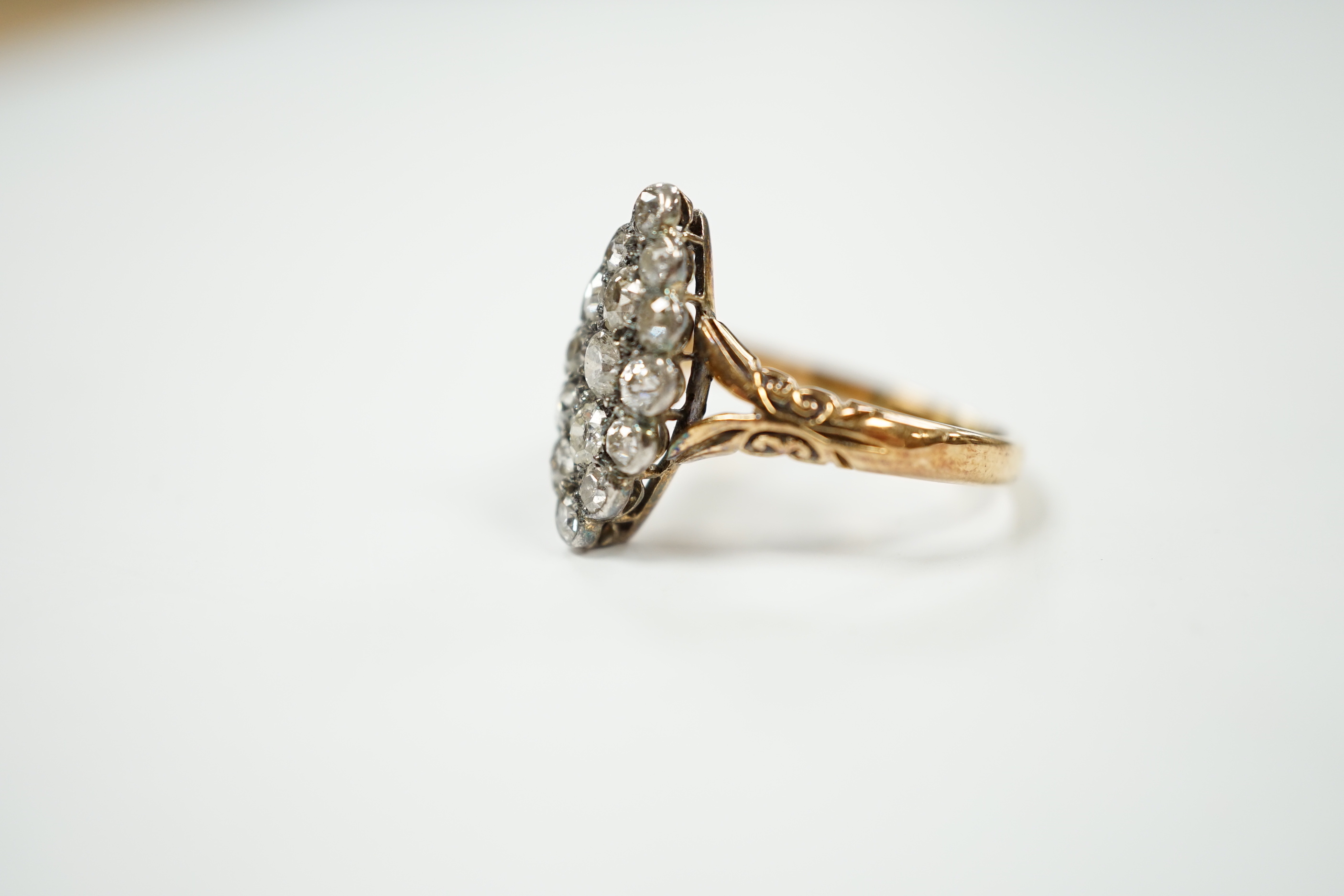 An 18ct and diamond set marquise cluster shaped ring, size N/O, gross weight 4 grams.